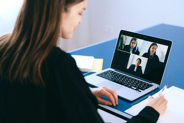 A woman sat on her laptop for a virtual interview